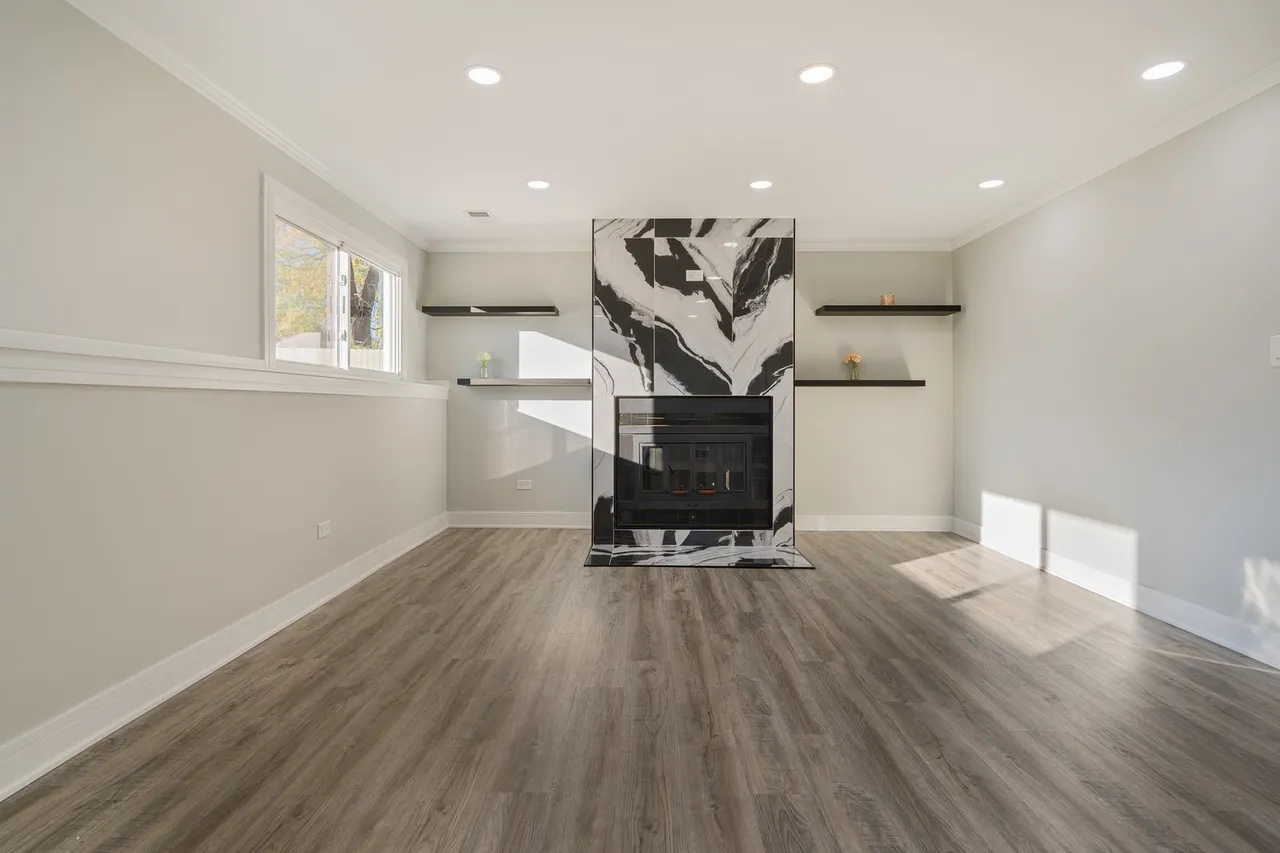 A clean room featuring hardwood floors and a cozy fireplace, ideal for home remodeling inspiration.